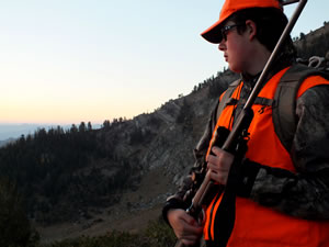 Dallen looking for elk as the sun is rising.
